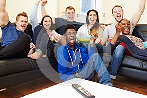 Group Of Friends Watching Television At Home Together