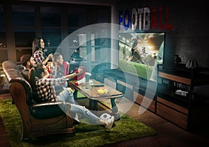 Group of friends watching TV, football match in France, sport games