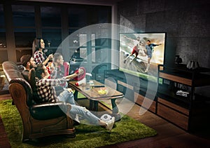 Group of friends watching TV, football match, sport together