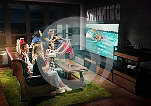 Group of friends watching TV, swimming, sport games