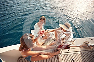 Group of friendâ€™s girl having party on sailing boat