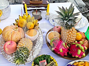 Group of fruits on white table prepare for worship god buddhism. Thailand people belief tradition culture. Tropical yellow fruit b