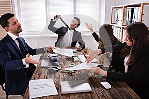 Group Of Frustrated Businesspeople In Meeting
