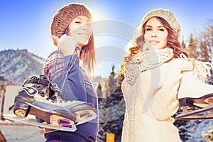 Group funny teenagers girls ice skating outdoor at ice rink