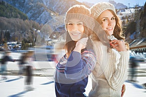 Group funny teenagers girls ice skating outdoor at ice rink