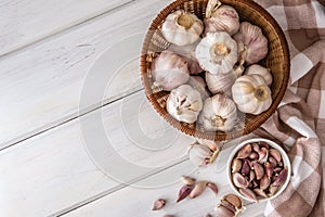 Group of garlic on white wooden table board , top view or overh photo