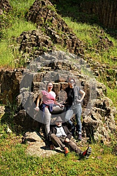 Group of geologists relaxing near volcanic rock