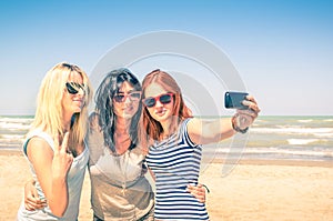 Group of girlfriends taking a selfie at the beach