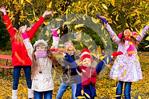 Group of girls in autumn park on the brench