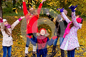 Group of girls in autumn park on the brench