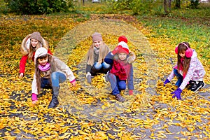 Group of girls in autumn park on the brench