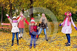 Group of girls in autumn park on the brench