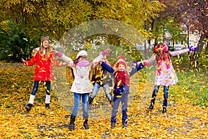 Group of girls in autumn park on the brench