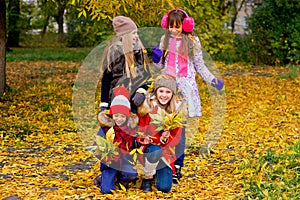 Group of girls in autumn park on the brench