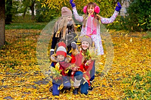 Group of girls in autumn park on the brench