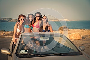 Group of girls at the beach with car