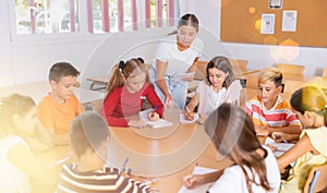 Group of girls and boys studying in school