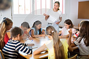 Group of girls and boys studying in school