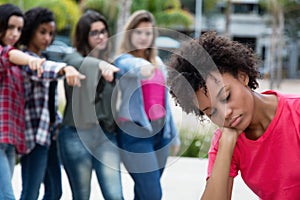 Group of girls bullying an african american woman