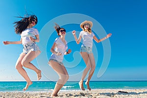 Group of girls enjoying summer on a tropical beach, a sunny day.