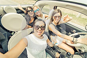 Group of girls having fun with the car