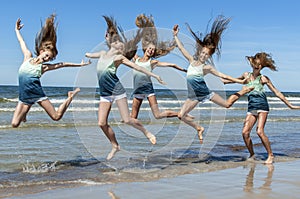 Group girls jumping on the beach