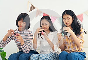 Group of girls se up their nail with polishes of different colors