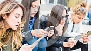 Group of girls with smartphones. Technology isolation and emotional depresion