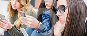 Group of girls with smartphones. Technology isolation and emotional depresion