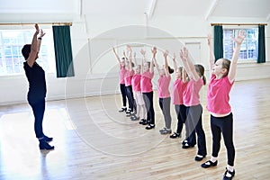 Group Of Girls In Tap Dancing Class With Teacher