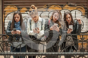 Group of girls using cellphones. Technology isolation and emotional depresion
