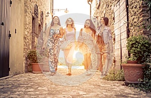 Group of girls walking in a historic center in italy