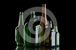 A group of glass bottles on a black isolated background
