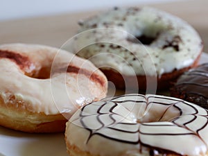 Group of glazed donuts on wooden background