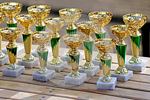 Group of golden trophies championship awards in row