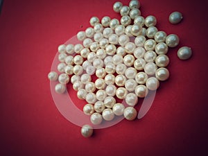 A group of golden and white pearls on brown background,costly,Golden and white glass bead