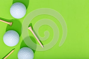 Group of golf balls and tee on green background