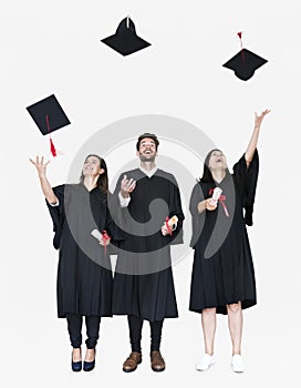 Group of grads throwing their hats in the air