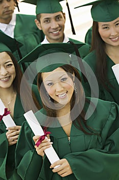 Group of graduates with diplomas elevated view