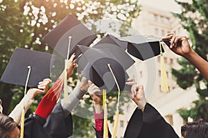 A group of graduates throwing graduation caps in the air