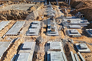 Group of graves placed atop a bare dirt field, showing a stark and somber scene of burial markers