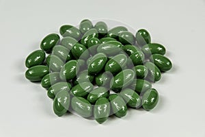 Group of green soft gelatine capsules.