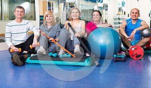 Group in gym with sport equipment