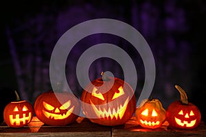 Halloween Jack o Lanterns at night against a spooky background