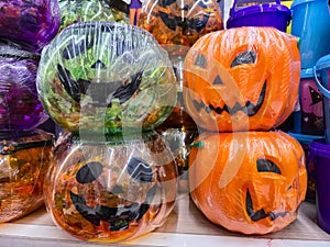 group of Halloween pumpkins filled with candy displayed for sale