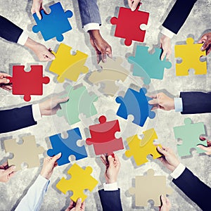 Group of Hands Holding Colourful Jigsaw Pieces