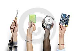 Group of hands holding computer electronics parts isolated on white