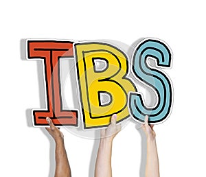Group of Hands Holding IBS Letter photo