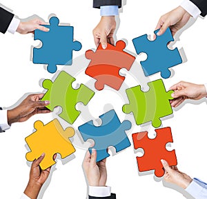 Group of Hands Holding Jigsaw Puzzle