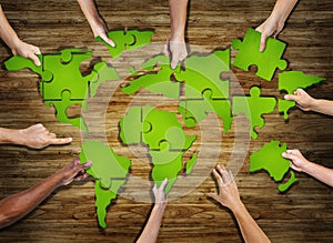Group of Hands Holding Jigsaw Puzzle Forming World